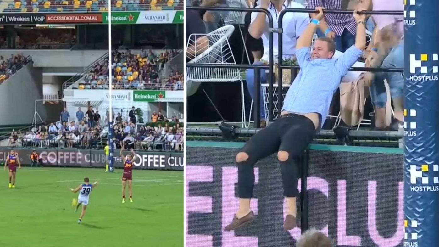 Watch: AFL punter flips over railing trying to catch ball at Lions v Suns