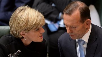 Julie Bishop holds discussions with Tony Abbott during a parliamentary sitting on September 2. (AAP Image/Alan Porritt)