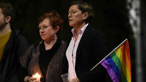 Christine Forster (right), the sister of former prime minsiter Tony Abbott, and partner Virginia Edwards attend a vigil in solidarity for the victims of the Orlando nightclub mass shooting on June 16. (AAP)