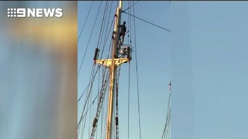 The man climbed to the top of the yacht's mast. (9NEWS)