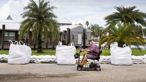 Before the arrival of Hurricane Ida in Jean Lafitte, Louisiana, Keith Clark used a friend's rope to help tie the houseboat before heading to Mandeville.  (Photo: Sophia Germer, NOLA.com, The Times-Picayune | New Orleans Lawyer)