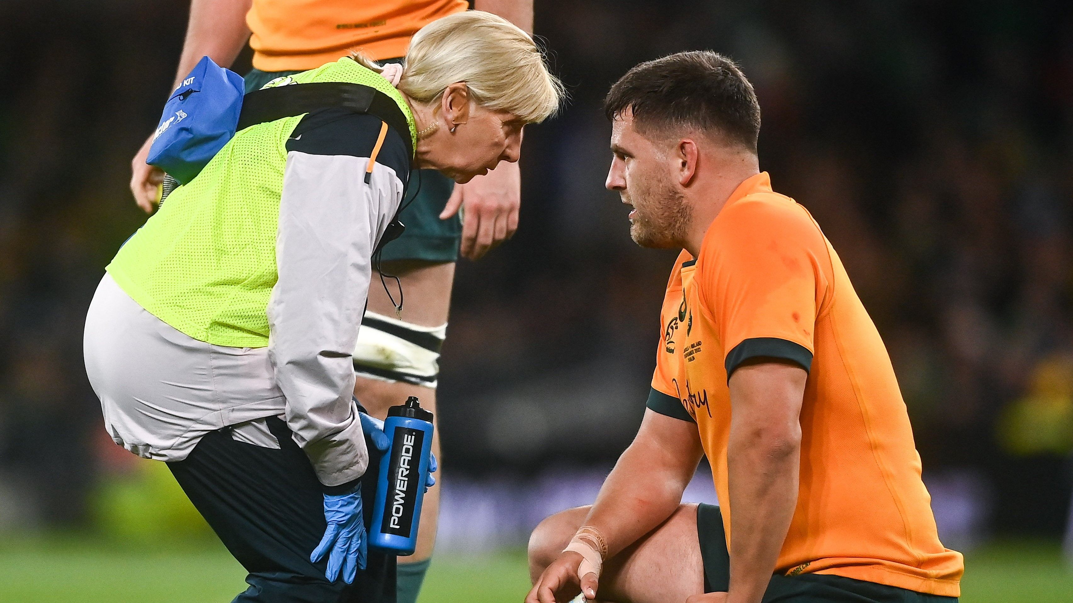 David Porecki receives medical attention, before being substituted off, during in the match between Australia and Ireland.