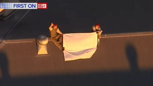 Prisoners on the roof of the Woodford Correctional Centre. (9NEWS)