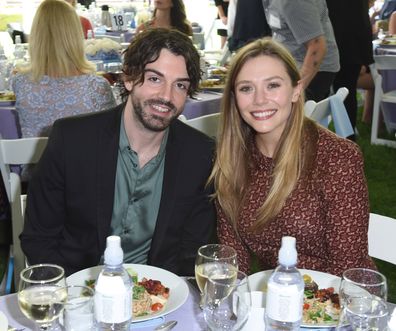 Robbie Arnett and Elizabeth Olsen attend The Rape Foundation's Annual Brunch on October 8, 2017 in Beverly Hills, California