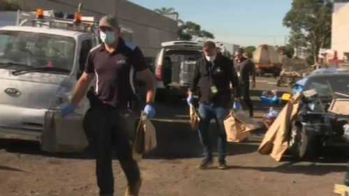 Police walk bags of evidence from the scene. (9NEWS)