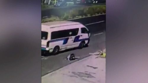 He is then seen waving his hands to get the attention of the bus. (Supplied)