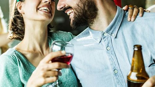 Woman drinking wine with friend