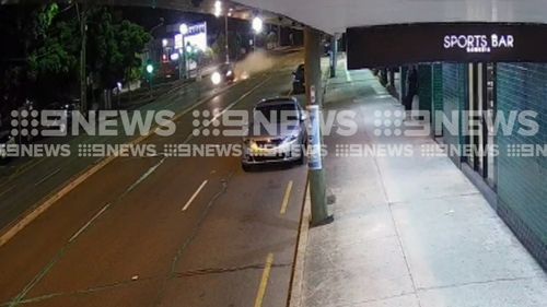 The speeding car smashed through a traffic light before flipping 100 metres down the highway.