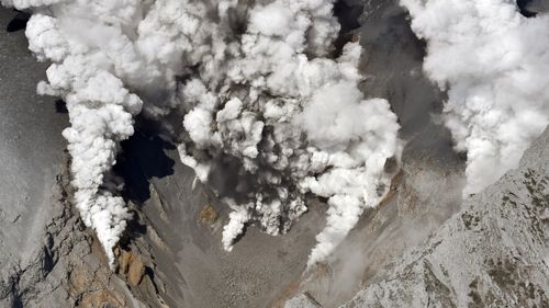 An aerial photo taken from Yomiuri Shimbun's helicopter shows the volcano of Mt. Ontake, spewing gray smoke up into the sky in between Gifu and Nagano Prefecture, central Japan. (AAP)