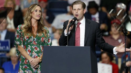 Lara Trump (L) , daughter in law of US President Donald J. Trump, looks on as her husband, the president's son Eric Trump (R) speaks during a 'Make America Great Again' rally at the Covelli Centre in Youngstown, Ohio, USA, 25 July 2017. (AAP)