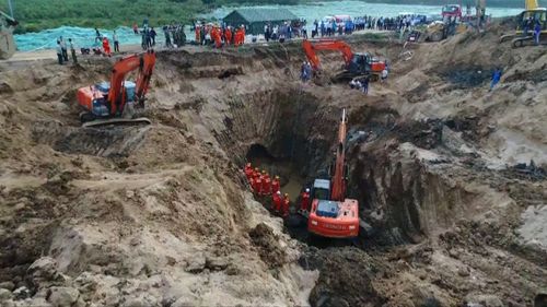 A dozen excavators and bulldozers from a nearby construction site came to help. (Reuters)