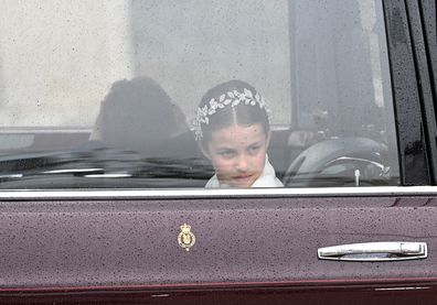 Princess Charlotte of Wales travelling in the state car during the Coronation of King Charles III and Queen Camilla on May 06, 2023 in London, England.