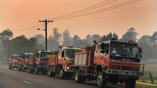 Rural Fire Service tankers at Moruya near Batemans Bay, in NSW, on Saturday. The region is bracing for temperatures in the high 40s.