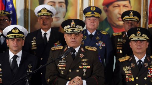 Venezuela's Defense Minister Vladimir Padrino Lopez, centre, has pledged the armed forces' support for President Maduro.