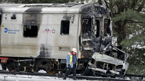 Six dead after packed commuter train crashes into car in New York