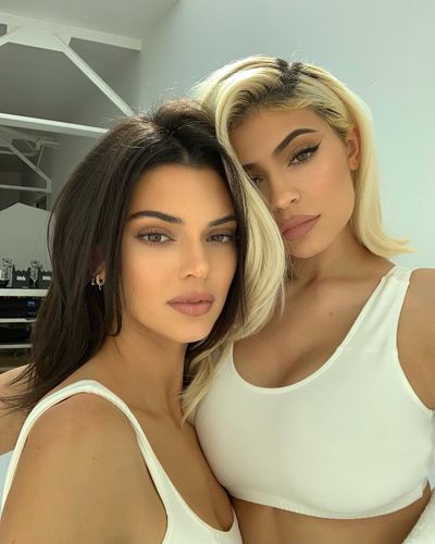 Kendall Jenner and Kylie Jenner pose in matching white sports bras during a photo shoot of new looks in their Kendall + Kylie clothing collection, 30, October, 2018.