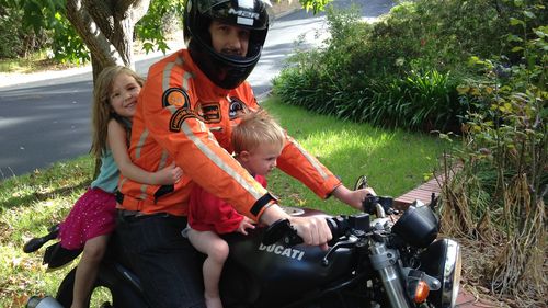 Leigh on his motorbike with his children, Zoe and Finn.