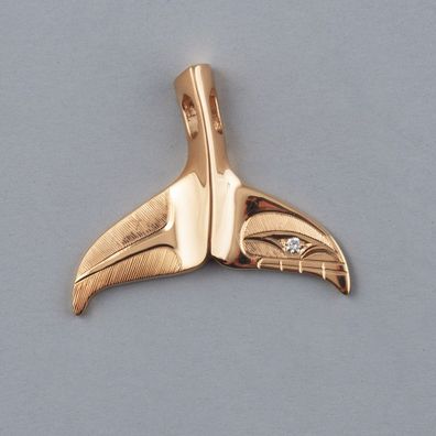The 18ct gold diamond whale tail charm was gifted to Meghan.