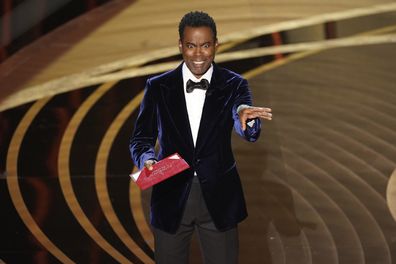 Chris Rock presents the award for best documentary feature at the Oscars on Sunday, March 27, 2022, at the Dolby Theatre in Los Angeles. (AP Photo/Chris Pizzello)