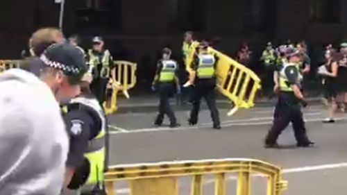 Police put up barricades as they fought to clear the area. (9NEWS/Sean Davidson)