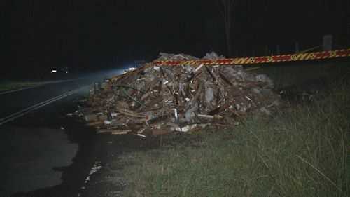 Giant pile of rubbish contaminated with asbestos found on fire in Sydney's south west