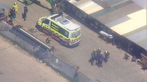 Two men have suffered electric shocks on a Sydney roof, with one man still stuck on top of the factory.