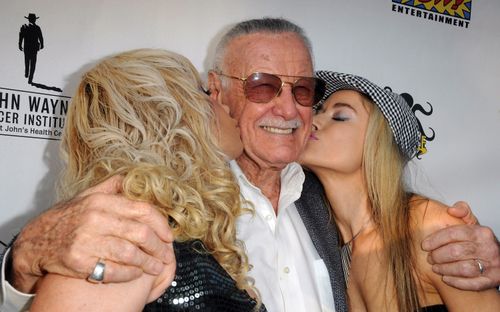 Actresses Diana Terranova and Paula Labaredas plant a kiss on Stan Lee at a charity auction for The John Wayne Cancer Institute in June 2012 in Culver City, California. Picture: WireImage