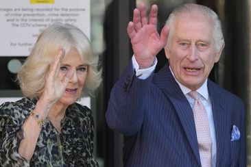 King Charles III and Queen Camilla wave as they arrive for a visit to University College Hospital Macmillan Cancer Centre in London, Tuesday, April 30, 2024.