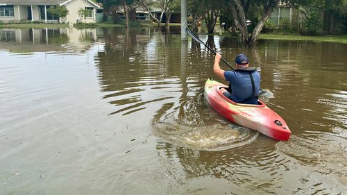 The Age photographer Jason South rows across flood water to get to a community stranded from the rest of Shepparton.