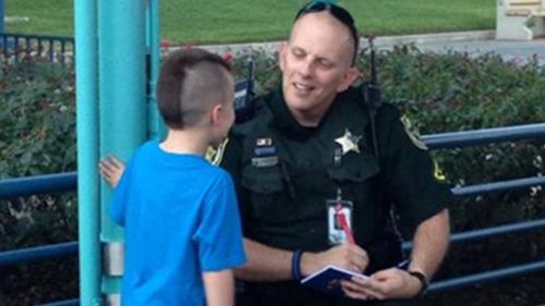 Forget Mickey Mouse -  this kid wants a police officer’s autograph