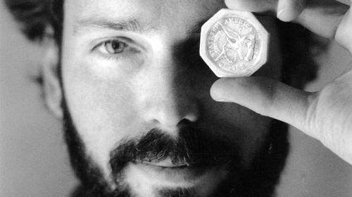 Tommy Thompson in 1989 holding a $50 pioneer gold piece retrieved from the wreck of the ship SS Central America.