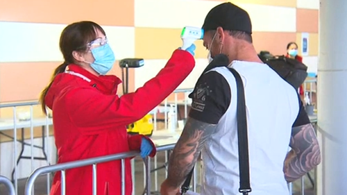 Rio Tinto workers get their temperatures checked at the testing facility at Perth Airport. 