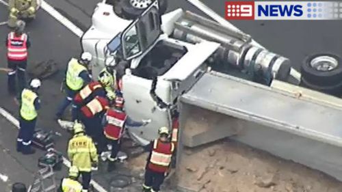 Sydney's M7 closed southbound after truck rollover near Hinchinbrook