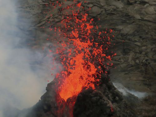 Lava erupts within the summit crater of Kilauea Volcano in Hawaii Volcanoes National Park on Hawaiis Big Island. 