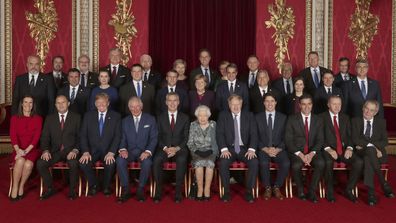 The Queen and Prince Charles pose for a 'class photo' with leaders of NATO alliance countries.