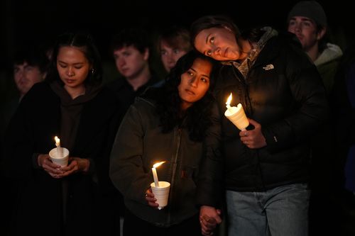 People gather at a vigil for the victims of Wednesday's mass shootings, Sunday, Oct. 29, 2023, outside the Basilica of Saints Peter and Paul in Lewiston, Maine.  