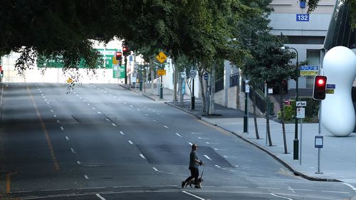 BRISBANE, AUSTRALIA - JULY 31: People are seen walking near the Brisbane CBD after lockdown on July 31, 2021 in Brisbane, Australia. Eleven local government areas in south-east Queensland will enter into a three-day lockdown from 4pm today as six new locally transmitted cases of the Covid-19 delta variant were reported.  (Photo by Jono Searle/Getty Images)