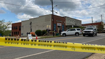 Investigators work at the site of a fatal shooting in downtown Dadeville, Ala., on Sunday, April 16, 2023.