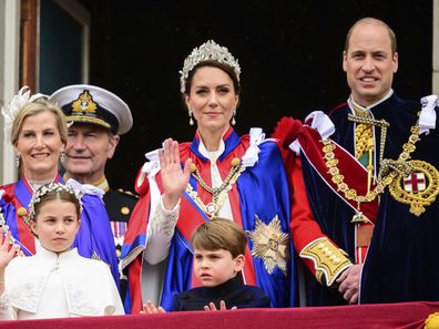 Kate, Princess of Wales, centre, waves from the balcony of Buckingham Palace with Prince William, right, Princess Charlotte, down left, and Prince Louis, down centre, during the coronation of Britain's King Charles III, in London, Saturday, May 6, 2023. 