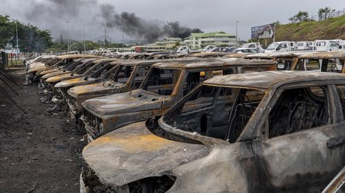 Burnt cars are lined up after unrest that erupted following protests over voting reforms.