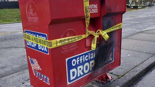 Police tape surrounds a ballot drop box damaged by a fire on Monday, Oct. 28, 2024, in Vancouver, Wash. (Monika Spykerman/The Columbian via AP)