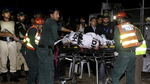A body is carried away from the scene of the blast.