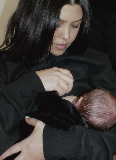 Kourney Kardashian breastfeeds her baby.