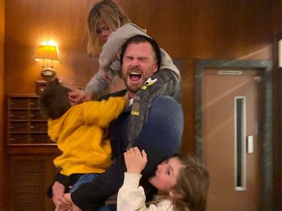 Chris Hemsworth being playfully attacked by his three kids