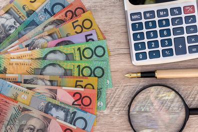 australian money next to a calculator
