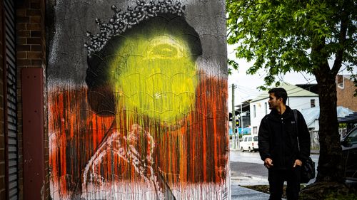 A mural in Sydenham of Queen Elizabeth II painted over with the Aboriginal flag