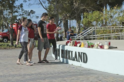 Students place flowers on the stage outside the Pines Trail Center in Parkland. Picture: AAP