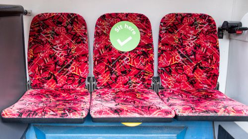 A green sticker shows where people can sit on buses.