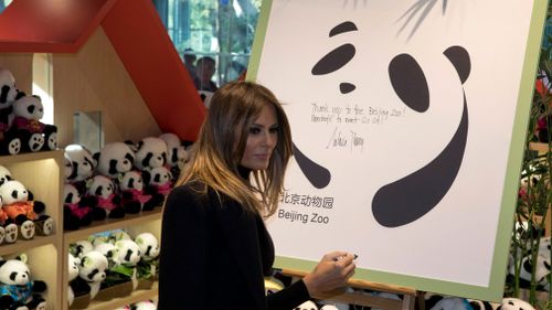Mrs Trump writes wishes on a board after visiting the Panda enclosure. (AAP)