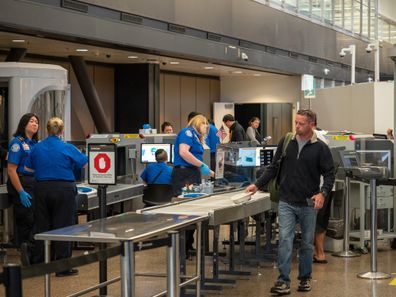 Seattle, WA AUGUST 26, 2018: Man passes though Transportation Security Administration TSA security checkpoint at Seattle-Tacoma International Airport.